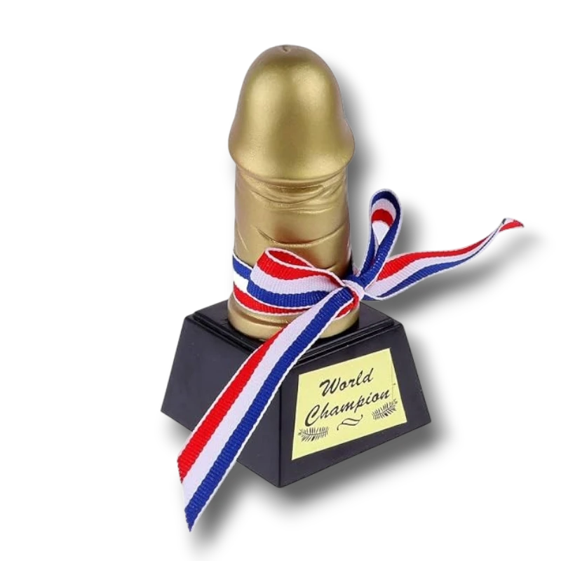 Trofeo de Willy PartyStore con forma fálica dorada, base negra y cinta tricolor con la inscripción World Champion